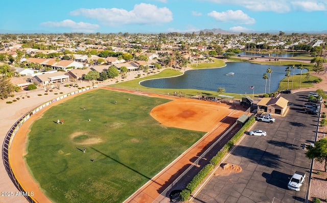 aerial view of residential area featuring a water and mountain view