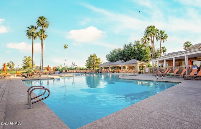 community pool featuring a patio and fence
