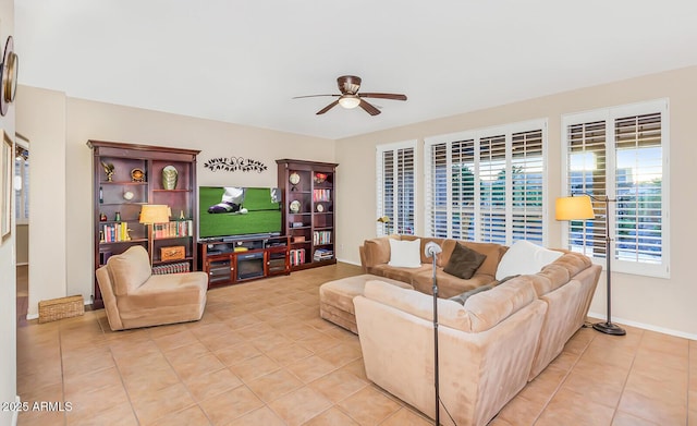 living room with a ceiling fan, light tile patterned floors, and baseboards