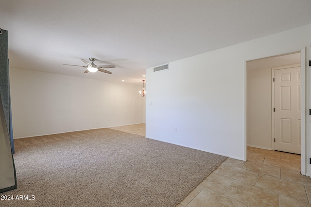 spare room featuring light colored carpet and ceiling fan