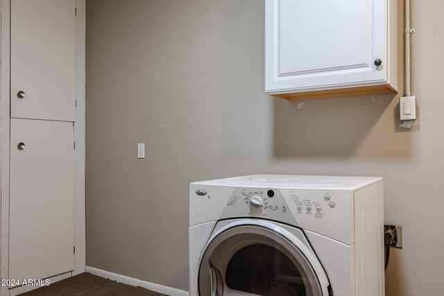 washroom featuring cabinets and washer / dryer