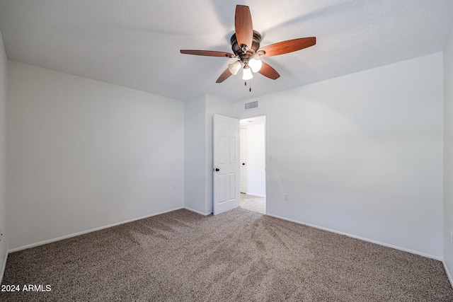 carpeted empty room featuring ceiling fan