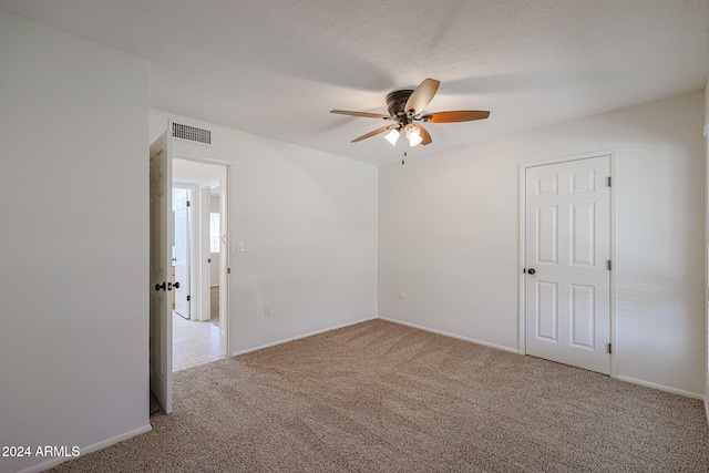 carpeted empty room with ceiling fan