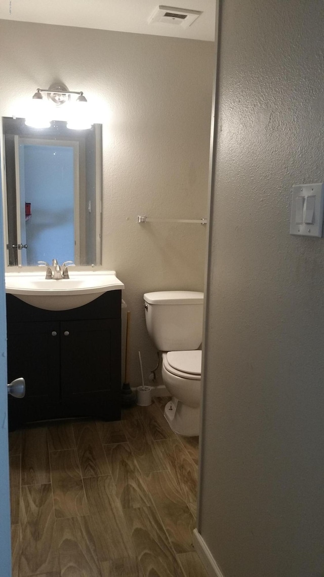 bathroom featuring toilet and vanity