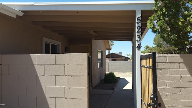 exterior view of fence and concrete block siding