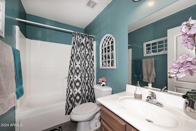 bathroom with vanity, shower / tub combo, toilet, and visible vents