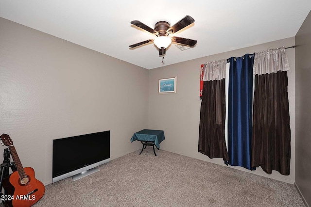 interior space featuring carpet flooring and a ceiling fan