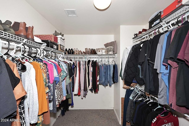 spacious closet featuring visible vents and carpet flooring