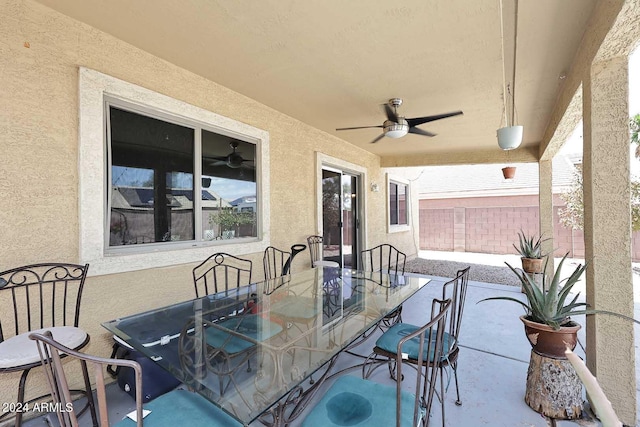 view of patio / terrace with outdoor dining space, ceiling fan, and fence