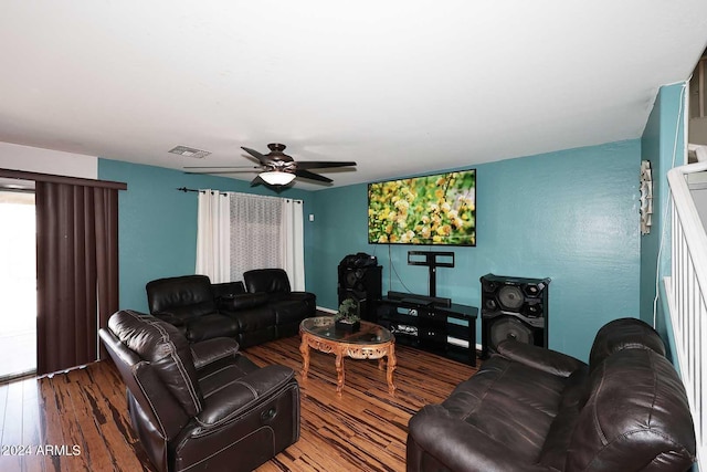 living area with wood finished floors, visible vents, and ceiling fan