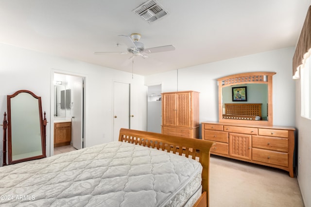 bedroom featuring ceiling fan, visible vents, and ensuite bathroom