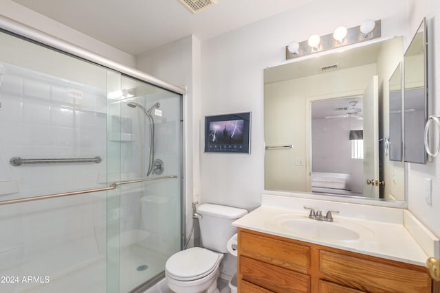 ensuite bathroom with a stall shower, visible vents, and toilet