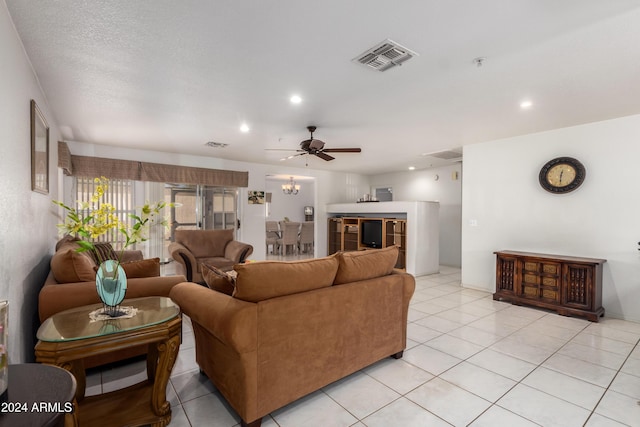 living area featuring light tile patterned floors, visible vents, a ceiling fan, and recessed lighting