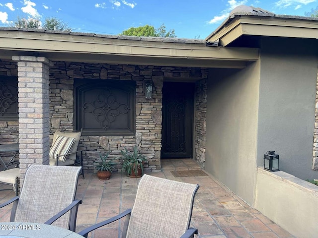 doorway to property with a patio area