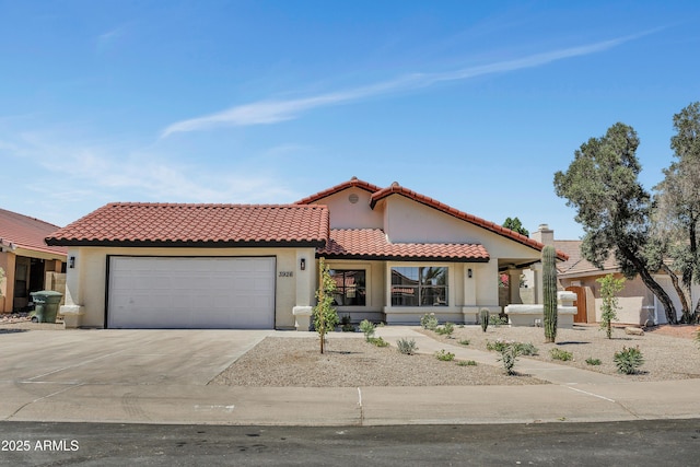 3926 E Coconino St, Phoenix, AZ 85044 - mediterranean / spanish-style house with an attached garage, concrete driveway, stucco siding, and a tiled roof