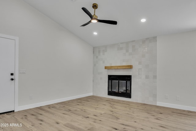 3926 E Coconino St, Phoenix, AZ 85044 - unfurnished living room featuring ceiling fan, wood finished floors, a tiled fireplace, vaulted ceiling, and recessed lighting
