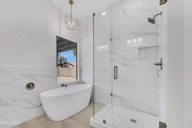 3926 E Coconino St, Phoenix, AZ 85044 - full bath with a marble finish shower, a freestanding tub, a chandelier, and tile walls