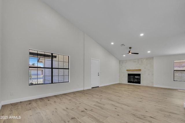 3926 E Coconino St, Phoenix, AZ 85044 - unfurnished living room with high vaulted ceiling, a ceiling fan, light wood-style floors, a glass covered fireplace, and recessed lighting