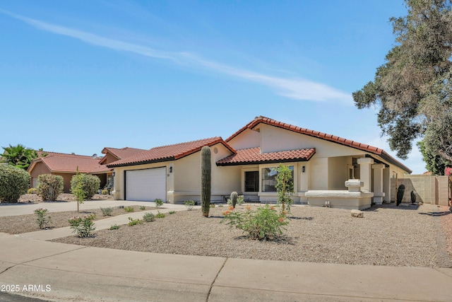 3926 E Coconino St, Phoenix, AZ 85044 - mediterranean / spanish home featuring stucco siding, a tiled roof, concrete driveway, and a garage