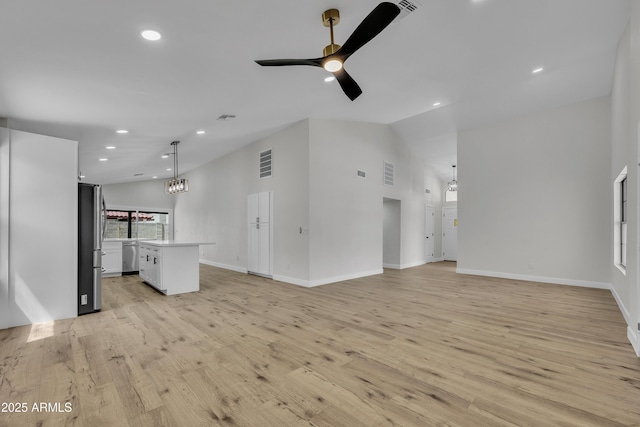 3926 E Coconino St, Phoenix, AZ 85044 - unfurnished living room with vaulted ceiling, a ceiling fan, light wood-style flooring, recessed lighting, and a chandelier