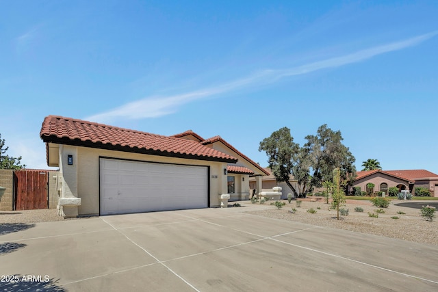 3926 E Coconino St, Phoenix, AZ 85044 - mediterranean / spanish house with a tiled roof, an attached garage, concrete driveway, and stucco siding