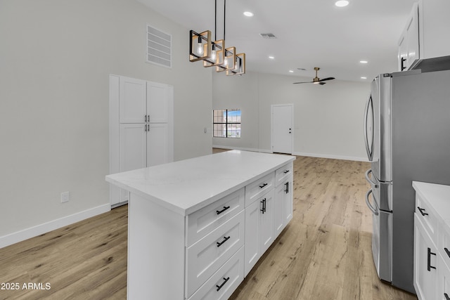3926 E Coconino St, Phoenix, AZ 85044 - kitchen with freestanding refrigerator, light wood-style floors, ceiling fan, a center island, and recessed lighting