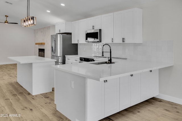 3926 E Coconino St, Phoenix, AZ 85044 - kitchen with stainless steel appliances, light wood finished floors, decorative backsplash, light countertops, and recessed lighting