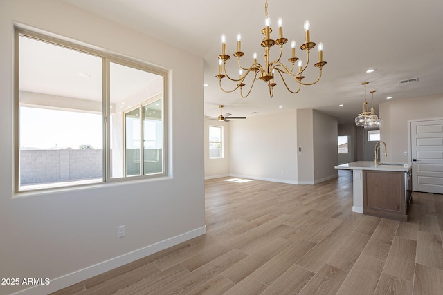 kitchen with light wood-style floors, visible vents, baseboards, and a ceiling fan