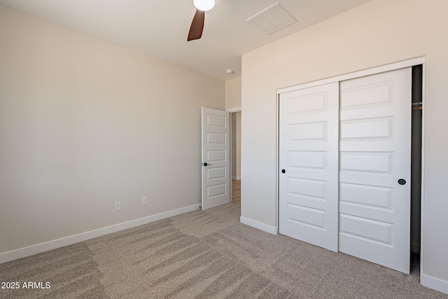 unfurnished bedroom featuring a closet, carpet flooring, visible vents, and baseboards