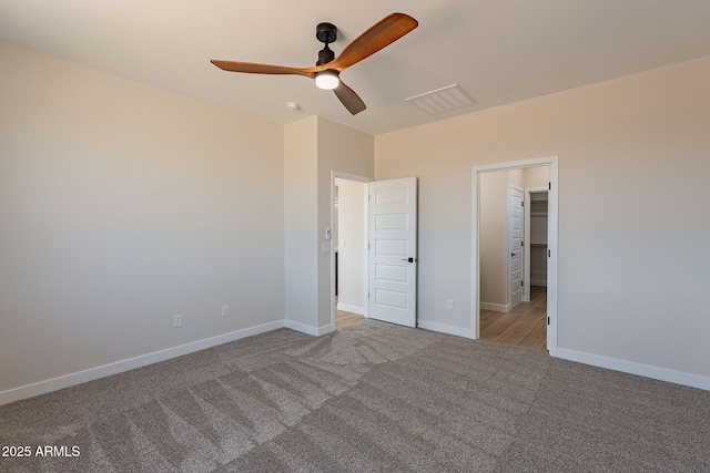 unfurnished bedroom featuring a ceiling fan, carpet, visible vents, and baseboards