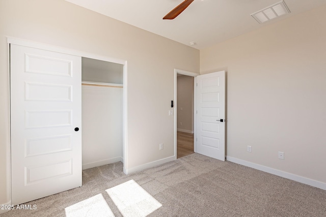 unfurnished bedroom with baseboards, visible vents, ceiling fan, carpet floors, and a closet