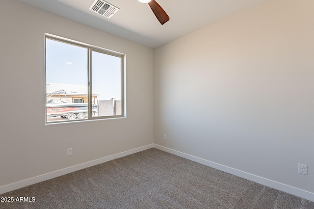 spare room with a ceiling fan, carpet, visible vents, and baseboards