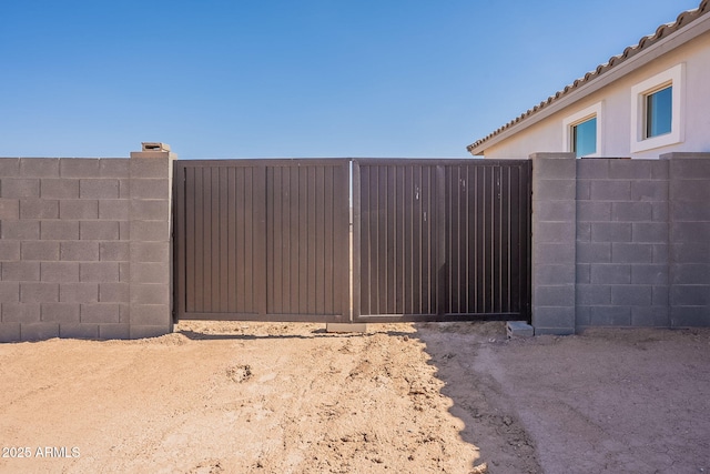 view of gate featuring fence