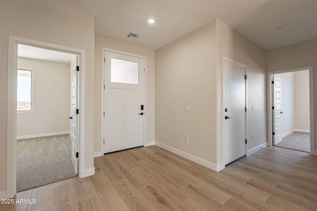 foyer featuring baseboards, recessed lighting, visible vents, and light wood-style floors