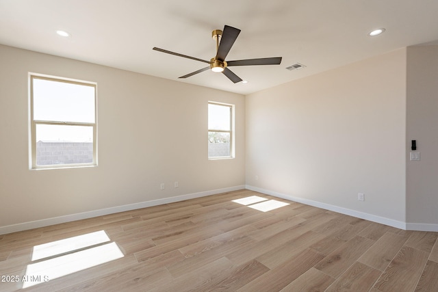 unfurnished room featuring light wood-style flooring, visible vents, baseboards, and recessed lighting