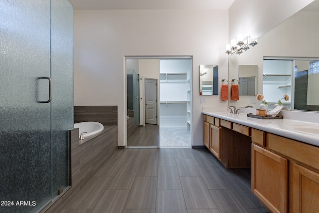 bathroom with vanity and separate shower and tub