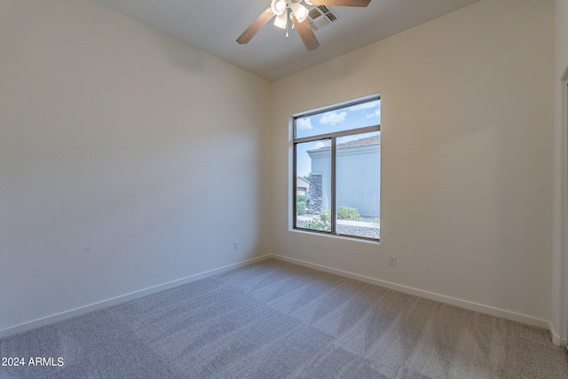 carpeted spare room with ceiling fan