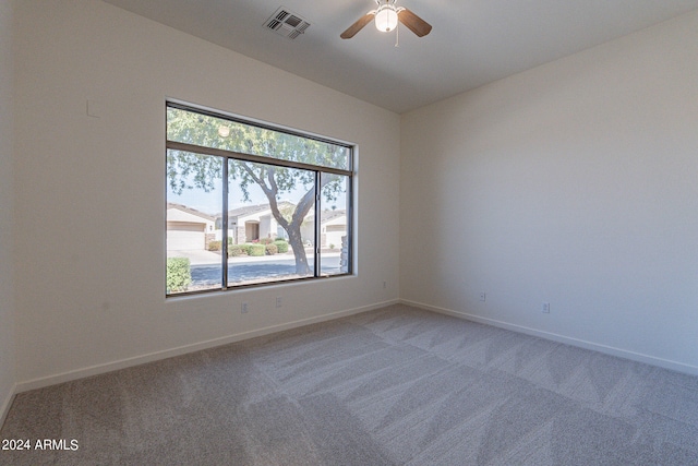 carpeted empty room featuring ceiling fan and vaulted ceiling