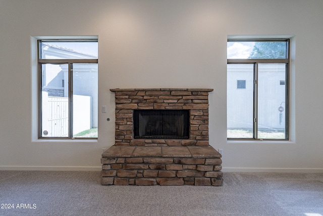 unfurnished living room with a fireplace and carpet flooring