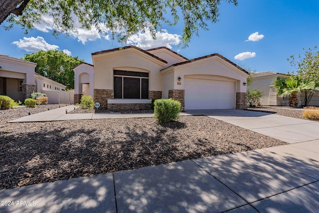 2223 E Branham Ln, Phoenix, AZ 85042 - ranch-style house with driveway, stone siding, fence, a garage, and stucco siding