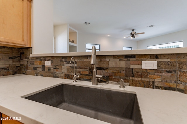 details with ceiling fan, decorative backsplash, sink, and light brown cabinets