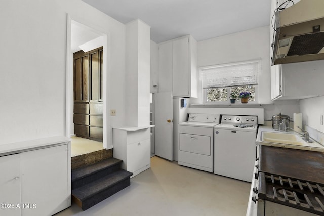 laundry room featuring cabinets and washer and dryer