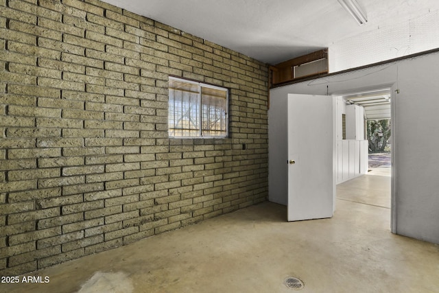 basement with brick wall and plenty of natural light