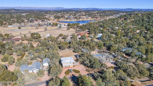 birds eye view of property featuring a water and mountain view