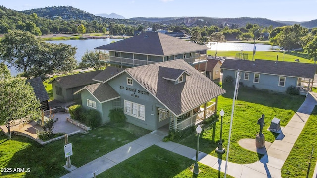 drone / aerial view featuring a water and mountain view