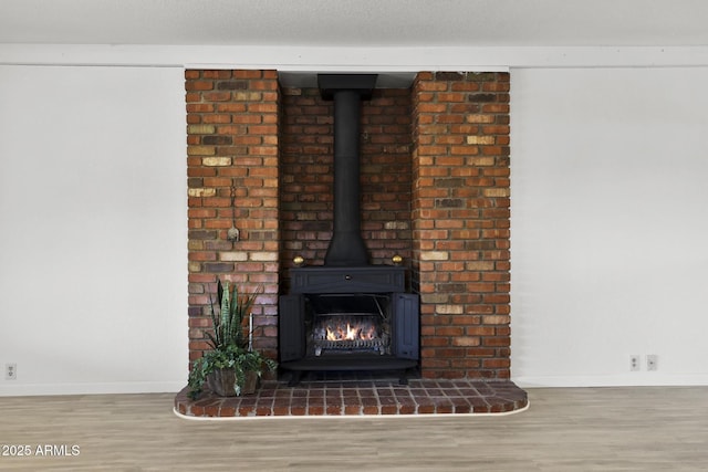 room details with wood-type flooring and a wood stove