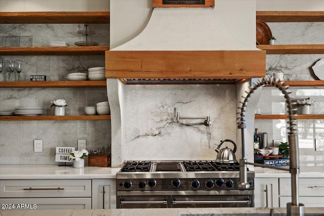 kitchen with tasteful backsplash and high end stainless steel range oven