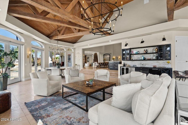 tiled living room with wood ceiling, an inviting chandelier, high vaulted ceiling, beamed ceiling, and french doors