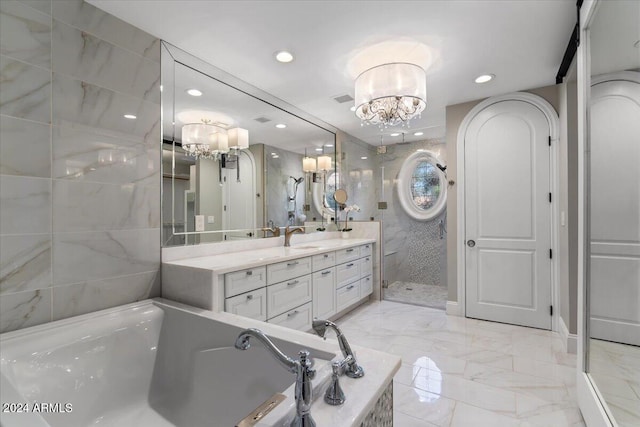 bathroom with vanity, an inviting chandelier, and shower with separate bathtub