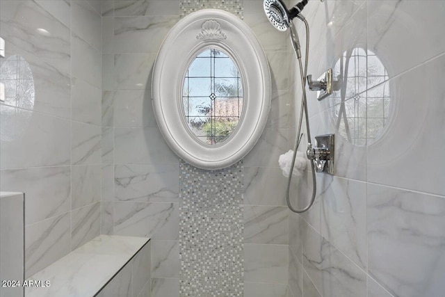 bathroom with tiled shower